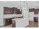 Modern kitchen boasts dark wood cabinets, granite countertops, and stainless steel appliances at 176 Van Winkle St, Lillington, NC 27546
