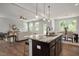 Open concept kitchen with island seamlessly connecting to the living and dining areas at 176 Van Winkle St, Lillington, NC 27546