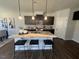 Modern kitchen with island, granite countertops, and dark cabinets at 176 Van Winkle St, Lillington, NC 27546