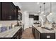 Stylish kitchen featuring an island, dark cabinets, countertops, and stainless appliances at 176 Van Winkle St, Lillington, NC 27546