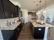 Modern kitchen with granite countertops and dark cabinetry at 176 Van Winkle St, Lillington, NC 27546