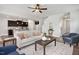 Bright open-concept living room featuring modern decor, ceiling fan, and hardwood floors at 176 Van Winkle St, Lillington, NC 27546