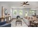 Spacious living room with modern furnishings, large windows and hardwood floors at 176 Van Winkle St, Lillington, NC 27546