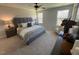 Main bedroom with king bed, carpet flooring and large windows at 176 Van Winkle St, Lillington, NC 27546