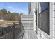 Private outdoor balcony with modern horizontal fencing and a view of the surrounding trees, perfect for relaxing at 4015 Elk Creek Ln, Raleigh, NC 27612