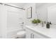 Clean bathroom featuring a shower-tub combo, stylish vanity, and modern fixtures at 4015 Elk Creek Ln, Raleigh, NC 27612