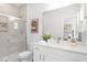 Well-lit bathroom featuring a glass-enclosed shower, toilet, and vanity, creating a spa-like retreat at 4015 Elk Creek Ln, Raleigh, NC 27612