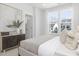 Sun-filled bedroom featuring soft, neutral tones, stylish furnishings, and large windows offering a serene and inviting atmosphere at 4015 Elk Creek Ln, Raleigh, NC 27612