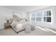 Bright bedroom featuring large windows, plush carpeting, and stylish decor at 4015 Elk Creek Ln, Raleigh, NC 27612