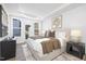 Bright bedroom with a large bed, stylish decor, and natural light from the sliding glass door to the outside at 4015 Elk Creek Ln, Raleigh, NC 27612