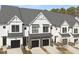 These modern townhomes boast dark brick accents, two-car garages, and matching black window awnings at 4015 Elk Creek Ln, Raleigh, NC 27612