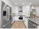 Modern kitchen features stainless appliances, ample cabinetry, and stylish tile backsplash at 4015 Elk Creek Ln, Raleigh, NC 27612