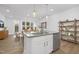 Modern eat-in kitchen with stainless dishwasher and large island, flowing into a cozy living space at 4015 Elk Creek Ln, Raleigh, NC 27612