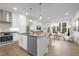 Modern kitchen island flows into the dining and living space, perfect for entertaining guests at 4015 Elk Creek Ln, Raleigh, NC 27612
