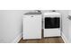Efficient laundry room with modern appliances and wood-look flooring at 4015 Elk Creek Ln, Raleigh, NC 27612