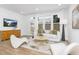 Bright and airy living room with large windows, stylish seating, and modern décor at 4015 Elk Creek Ln, Raleigh, NC 27612