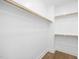 A bright walk-in closet features multiple wooden racks for ample storage space and modern white trim at 4015 Elk Creek Ln, Raleigh, NC 27612