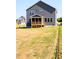 Exterior of the home showcasing the backyard and screened-in porch at 592 Barbour Farm Ln, Four Oaks, NC 27524