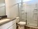 Modern bathroom with a stylish vanity, toilet, and a glass-enclosed shower for a spa-like experience at 592 Barbour Farm Ln, Four Oaks, NC 27524