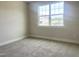 Bright bedroom offers plush carpeting, neutral walls, and a large window providing ample natural light at 592 Barbour Farm Ln, Four Oaks, NC 27524