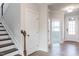 Inviting entryway showcases the staircase, wood-look flooring, and natural light at 592 Barbour Farm Ln, Four Oaks, NC 27524