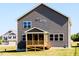 Exterior elevation featuring a screened-in porch and gray vinyl siding at 592 Barbour Farm Ln, Four Oaks, NC 27524