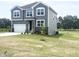 Attractive two-story home with gray siding, stone accents, and a pristine lawn in a desirable location at 592 Barbour Farm Ln, Four Oaks, NC 27524