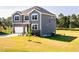 Two-story home with an attached garage, stone accents, and a lush green lawn at 592 Barbour Farm Ln, Four Oaks, NC 27524