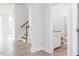 Hallway with access to a half bathroom and staircase with wood-look flooring at 592 Barbour Farm Ln, Four Oaks, NC 27524