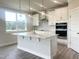 Modern kitchen features a large island, white cabinets, and stainless steel appliances for culinary enthusiasts at 592 Barbour Farm Ln, Four Oaks, NC 27524