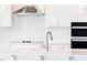 Close-up of the kitchen island, featuring a stainless steel faucet and modern appliances at 592 Barbour Farm Ln, Four Oaks, NC 27524