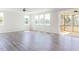 Bright living room featuring luxury vinyl plank flooring and access to a screened-in porch at 592 Barbour Farm Ln, Four Oaks, NC 27524