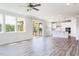 Open-concept living area with light-filled kitchen, hardwood floors, and screened patio at 592 Barbour Farm Ln, Four Oaks, NC 27524