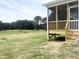 Charming screened porch with views of the golf course, providing a serene outdoor living space at 592 Barbour Farm Ln, Four Oaks, NC 27524