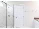 Bathroom featuring a frameless glass shower with marble tile and chrome fixtures at 592 Barbour Farm Ln, Four Oaks, NC 27524