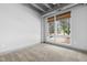 Bright carpeted bedroom with a large window offering a view of the outdoor foliage at 1300 St Marys St # 208, Raleigh, NC 27605