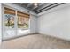 Empty carpeted bedroom with a double-pane window showing outdoor scenery at 1300 St Marys St # 208, Raleigh, NC 27605