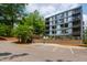Modern apartment building with parking spaces and lush landscaping, perfect for relaxation at 1300 St Marys St # 208, Raleigh, NC 27605
