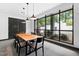 Bright dining room features a modern wooden table and natural light from a large window at 1300 St Marys St # 208, Raleigh, NC 27605