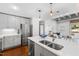 Bright, open kitchen with stainless steel appliances and connected living area at 1300 St Marys St # 208, Raleigh, NC 27605