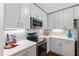 Modern kitchen with stainless steel appliances and white subway tile backsplash at 1300 St Marys St # 208, Raleigh, NC 27605