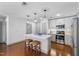 Kitchen featuring a central island, stainless steel appliances, and modern pendant lighting at 1300 St Marys St # 208, Raleigh, NC 27605