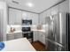 Modern kitchen with stainless steel appliances, white cabinets, and sleek countertops at 1300 St Marys St # 208, Raleigh, NC 27605