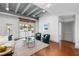 Bright living room featuring exposed ceiling, sliding glass doors, and stylish seating arrangement at 1300 St Marys St # 208, Raleigh, NC 27605