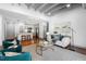 Open-concept living area featuring a modern white sofa, teal chairs, and a view of the kitchen at 1300 St Marys St # 208, Raleigh, NC 27605