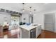 Open-concept living space with a view from the kitchen to the living room, featuring an island at 1300 St Marys St # 208, Raleigh, NC 27605