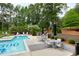 Community pool with tables, chairs, and grill for entertaining friends and Gathering at 1300 St Marys St # 208, Raleigh, NC 27605