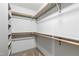 Walk-in closet with wooden shelving; well-lit for easy access at 1300 St Marys St # 208, Raleigh, NC 27605