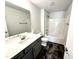 Bathroom with dark wood-look floors, a gray vanity, white countertop and tub/shower combo at 122 Southern Estates Dr, Sanford, NC 27330