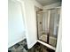 Modern bathroom featuring a glass-enclosed shower with tiled walls, and sleek black floors at 122 Southern Estates Dr, Sanford, NC 27330